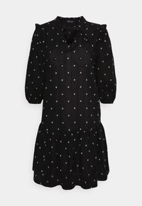 Vestido curto preto com padrão prateado pontilhado, mangas bufantes, decote em forma de buraco com laços e saia rodada. Feito de tecido leve.