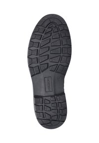 Semelle de chaussure en caoutchouc noir avec des motifs de crantage profonds, logo rectangulaire de Nelson, et numéro de taille 31 visible près de la zone de la voûte.
