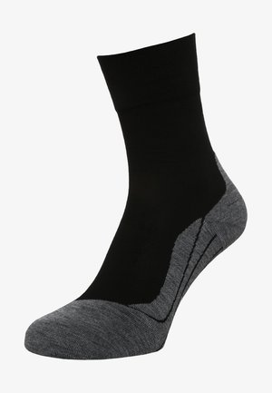 Schwarze und graue Knöchelsocke mit glatter Textur, geripptem Bund und einer kontrastierenden dunkelgrauen Ferse mit einem gemusterten Design.