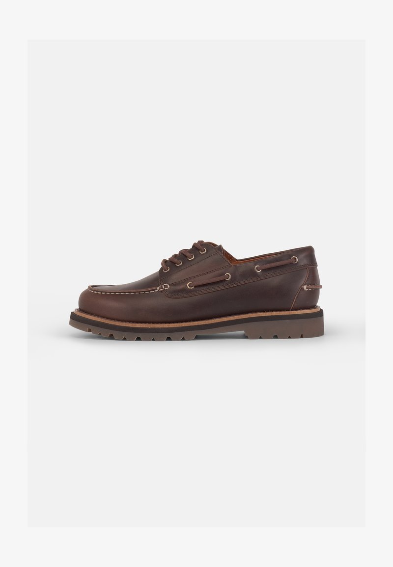 Brown leather boat shoe with a rounded toe, six eyelets, contrasting stitching, and a textured rubber sole.
