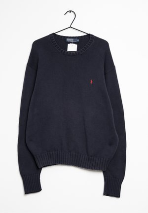 Pull en maille bleu marine à col rond avec poignets et bas côtelés, suspendu sur un cintre noir, avec un petit logo joueur de polo rouge sur la poitrine.