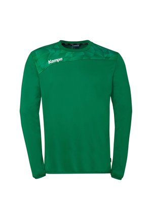 Grünes langärmliges Sportshirt mit geometrischem Muster auf der oberen Brust und "Kempa"-Logo auf der linken Schulter.
