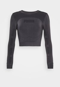 Svart kortärmad topp med lång ärm gjord av stretchigt material. Har Puma-logotypen på bröstet och längs ärmarna, med en figurnära design och mjuk textur.