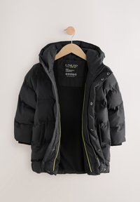 Veste matelassée noire avec capuche, dotée d'une fermeture éclair à l'avant, de boutons-pression et de détails accentués jaune vif sur les coutures. Doublure intérieure douce.