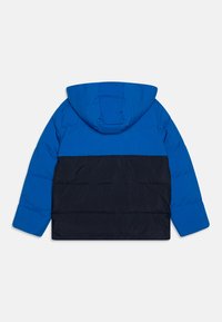 Blue and black puffer jacket with a hood. Features a quilted design and contrasting color paneling. Made from soft, lightweight material.