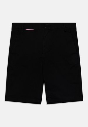 Zwarte shorts van geweven stof, met voorzakken, een knoopsluiting en minimale stikseldetails.