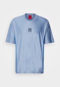 Light blue sports t-shirt with a textured pattern, crew neckline, contrast blue side accents, and a grey logo on the chest.