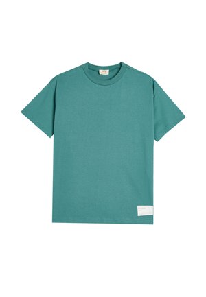 Camiseta de algodón color teal con mangas cortas, cuello redondo y una etiqueta rectangular en la parte inferior que muestra el texto "el océano".