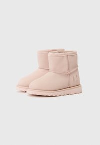 Pink suede ankle boots with a rounded toe, stitched seam detailing, and a textured rubber sole. Features embossed logo on the side.
