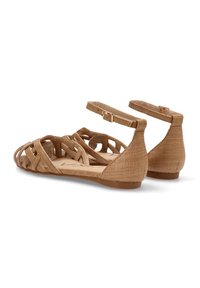 Sandalias planas tejidas de color marrón con diseño entrecruzado, correa en el tobillo y parte superior de tela texturizada. Tacón bajo y plantilla acolchada.