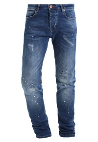 Modré denimové džínsy s úzkym strihom, s vyblednutými miestami, jemným vyblednutím a malými bielymi škvrnami od farby pre extra detaily.