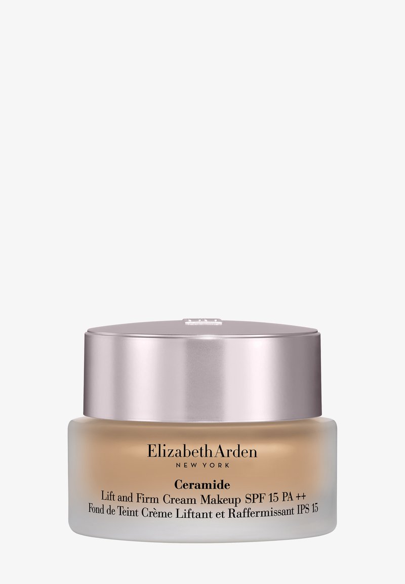 Krem do makijażu Elizabeth Arden Ceramide Lift and Firm w przezroczystym szklanym słoiku z srebrną pokrywką, zawierający beżowy krem. Oznaczony SPF 15.