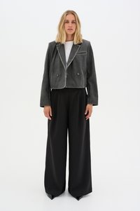 Gray cropped jacket with a notched collar, two buttons, and a subtle sheen, paired with high-waisted black wide-leg trousers.