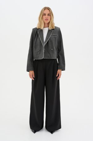 Gray cropped jacket with a notched collar, two buttons, and a subtle sheen, paired with high-waisted black wide-leg trousers.