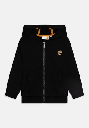Sweat à capuche noir zippé avec une poche kangourou, capuche doublée en orange et un petit logo brodé sur la poitrine. Tissu en mélange de coton.