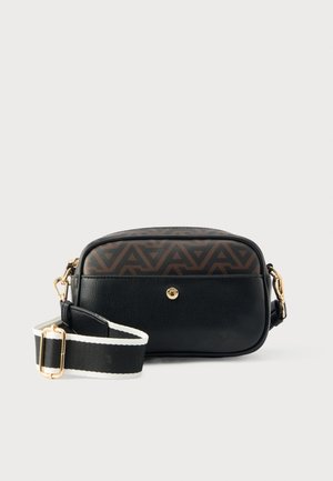 Black leather crossbody bag with a geometric brown pattern on top, gold hardware, and a black and white striped adjustable strap.