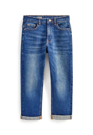 Jean en denim bleu coupe ample avec poches avant et poche monnaie, coutures visibles et revers roulés sur fond blanc.
