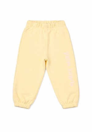 Pantalon de jogging jaune clair avec taille et poignets élastiques, avec un texte vertical blanc "palm angels" sur la jambe droite.