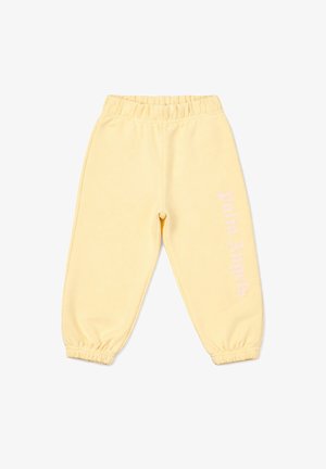 Pantalon de jogging jaune clair avec taille et poignets élastiques, avec un texte vertical blanc "palm angels" sur la jambe droite.