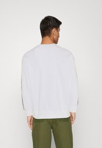 Levi's® RELAXED GRAPHIC CREWNECK SWEATSHIRT - Melegítőfelső - white