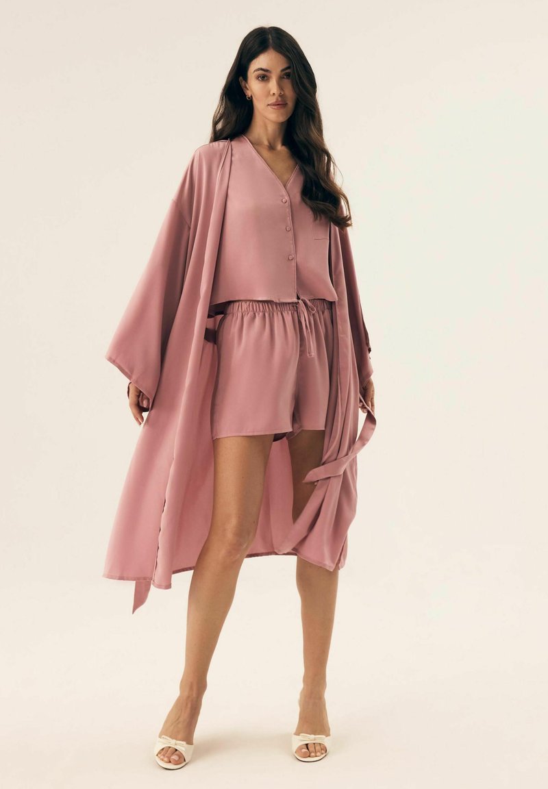 Jasnoróżowy komplet z satyny, składający się z koszuli na guziki, szortów z elastycznym pasem oraz dopasowanego długiego kimona z szerokimi rękawami.