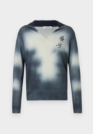 V-kaula-aukollinen villapaita, jossa on laivastonsinisen ja kerman sävyjen liuku, resorit hihansuissa ja helmassa, vasemmassa rinnassa kirjailtu hahmo.