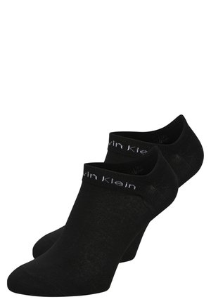 Chaussettes noires coupées au niveau de la cheville, fabriquées dans un matériau doux, avec un bord côtelé et un logo "Calvin Klein" en blanc tissé sur le dessus.