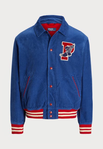 Blue corduroy jacket with red and white striped cuffs and hem. Features a front patch with a winged letter "P" and snap-button closure.
