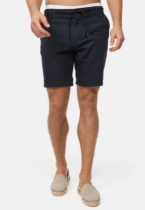 Șorturi de baie bleumarin dintr-un material ușor, cu talie elastică și șnur, având buzunare laterale. Design mai casual.