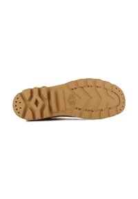 Suola di scarpa in gomma color sabbia con scanalature profonde e motivi in rilievo. Presenta indentazioni circolari e a forma di diamante per una migliore aderenza.