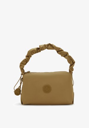 Brown, soft-textured bag with a gathered handle, zipper closure, and a circular logo patch. Features a small charm attached to the zipper.