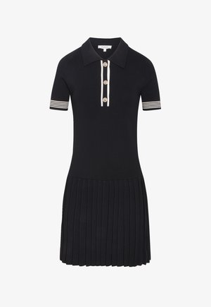 Zwarte polo jurk met korte mouwen en witte gestreepte manchetten, geplooide rok, drie gouden knopen op de voorste plooi en een kraag.