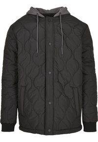 Veste matelassée noire avec boutons-pression à l'avant, poches latérales, poignets côtelés et capuche grise fixée avec cordons.