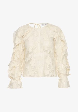 Cremefarvet bluse i blonde med flæser og lange ærmer samt knydebånd ved halsen. Blomstermønster over hele blusen med samlede ærmer og tætsiddende manchetter.