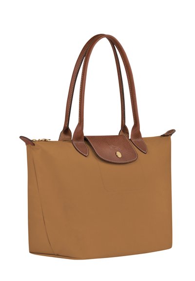 Brown nylon tote bag with dual leather handles, rectangular shape, logo-embossed flap closure, and a subtle textured leather accent.