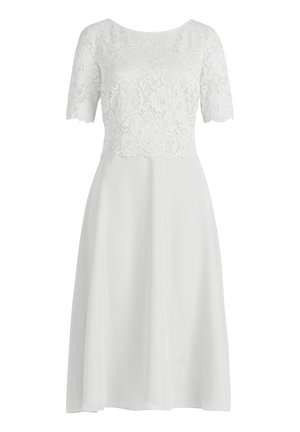 White dress with a sheer lace top and short sleeves; A-line silhouette; smooth, flowing fabric; scalloped lace edges.