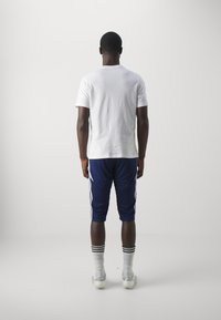 adidas Performance TIRO24  - 3/4 pikkuses spordipüksid - team navy blue/white