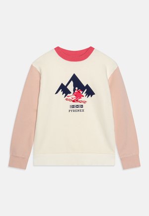 Sweatshirt blanc avec des manches roses, col rond rouge. Présente un graphique de montagne bleu marine et une impression de skieur rouge, avec le texte "BONXON PYRENEEX".