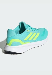 Turquoise running shoe with a mesh upper, yellow accents, padded collar, and a white midsole. Features a textured outsole for grip.