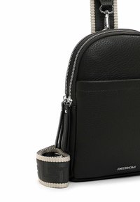 Black textured leather crossbody bag with dual silver zippers, external pocket, and adjustable black and beige woven strap.