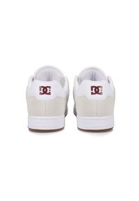White and gray shoes with a suede and leather upper, featuring a maroon logo patch on the heel and a rubber sole.