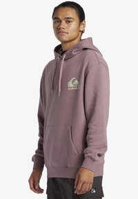 Purple hoodie made of cotton blend, featuring a front pocket, drawstring hood, and a green logo graphic on the chest.