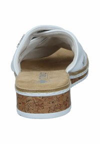 White open-back sandal with a cork platform and textured footbed. The interior features soft cushioning and a smooth lining.