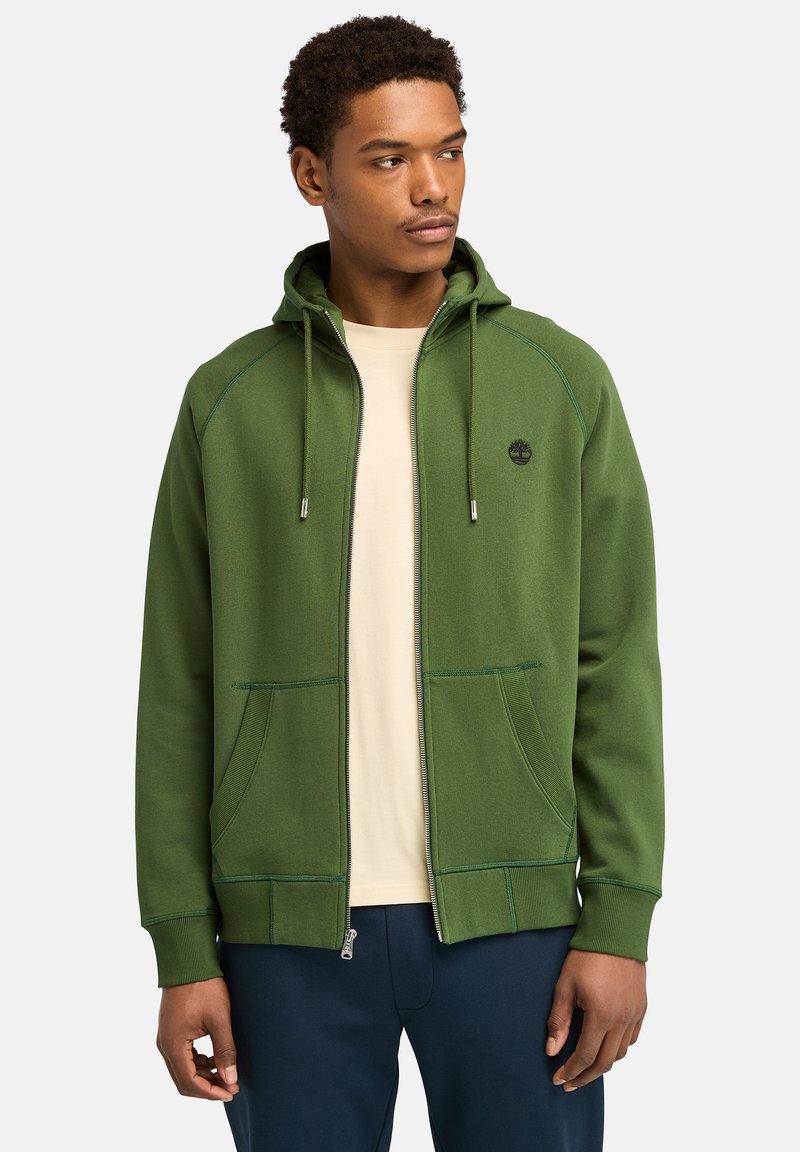 Grüne Zip-Hoodie aus weichem Stoff, mit einer Fronttasche, verstellbaren Kordeln und kontrastierenden Nähten.