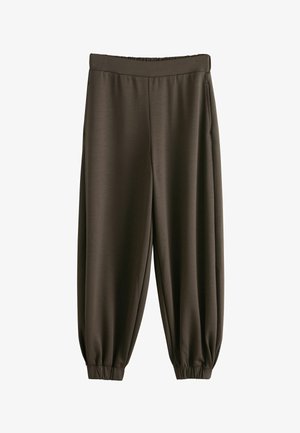 Tamsiai rudos spalvos laisvo kirpimo sportinės kelnės su elastinga liemene ir rankogaliais, šoniniais kišenėmis ir lygiu audinio paviršiumi.