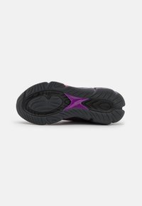 Purple and black athletic shoe outsole with textured rubber, featuring a wave pattern and a prominent purple accent in the midfoot area.