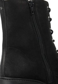 Black leather ankle boot with a textured finish, featuring a side zipper and metal eyelets for laces, with a rounded toe and sturdy sole.