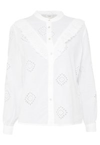 Blouse blanche à manches longues avec fermeture à boutons, bordure en dentelle festonnée et motifs floraux brodés sur toute la surface. Confectionnée en tissu léger.