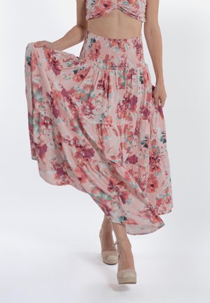 Gonna maxi floreale in rosa pastello, con vita arricciata e design a strati e fluido. Realizzata in tessuto leggero con una texture morbida.