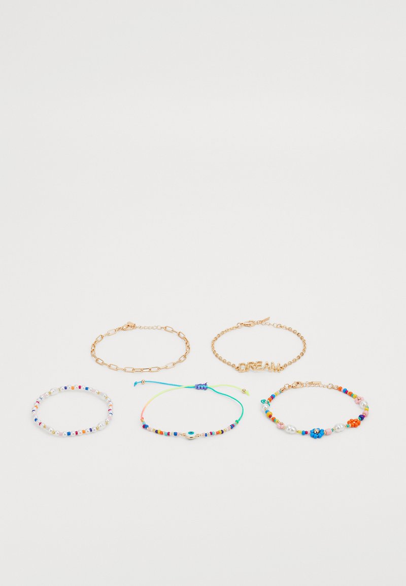 Five bracelets featuring varying designs: a gold chain, colorful beads, and a “DREAM” accent. Materials include metal and glass beads.